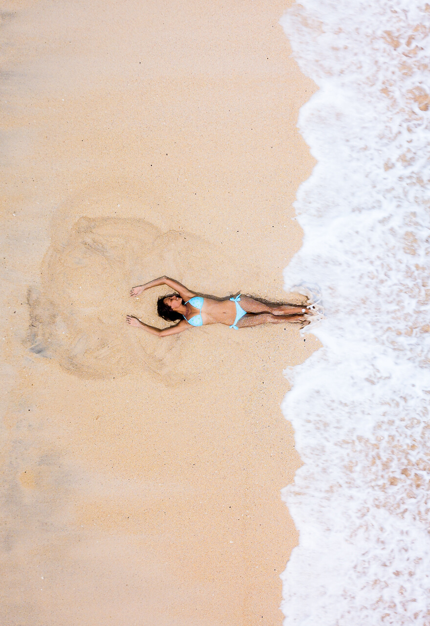 girl on the beach from drone